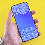 hand holding smartphone with social media icons